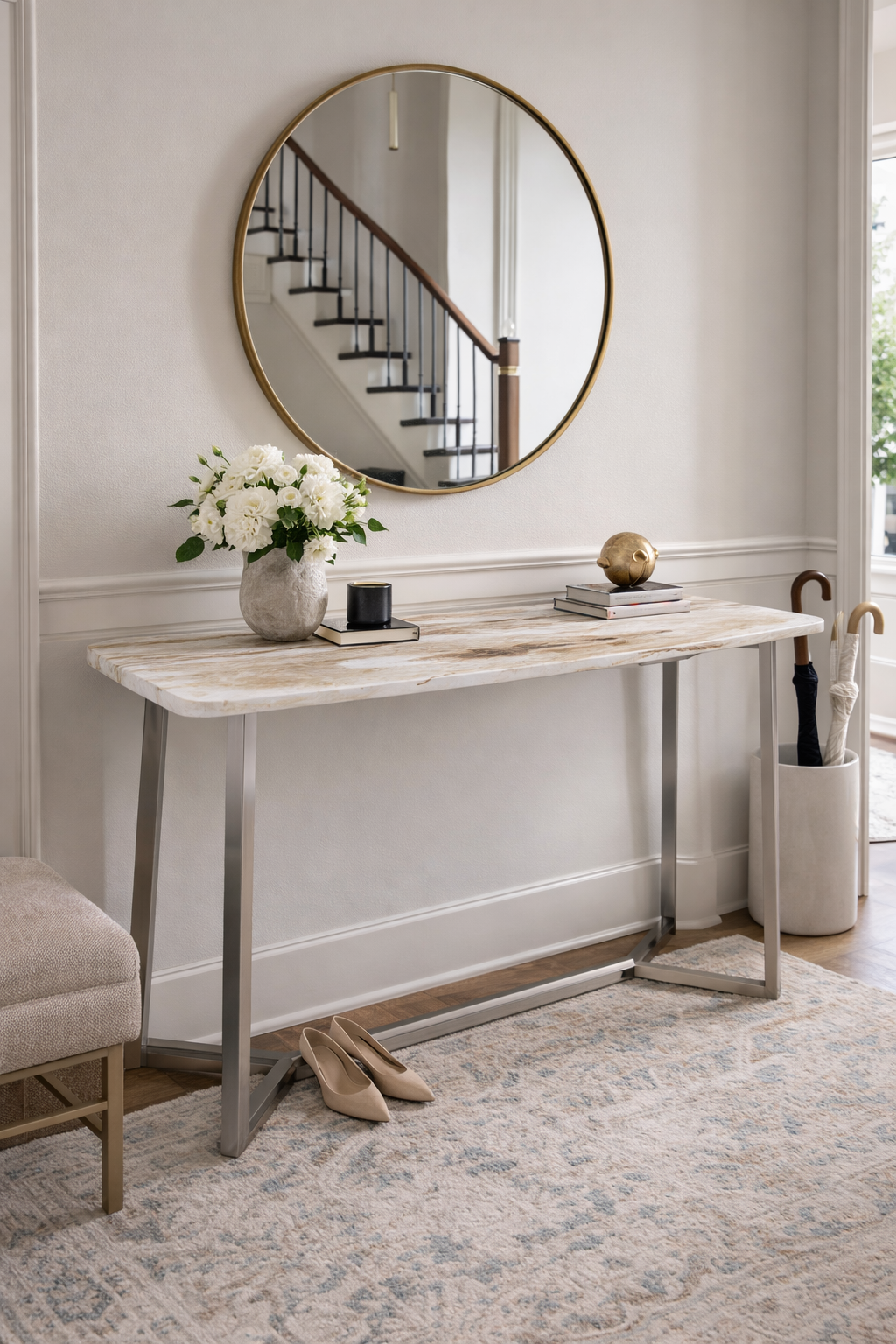 Console table with decorative items against a wall with a round mirror.