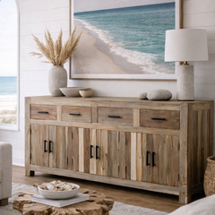 Wooden sideboard with beach-themed decor in a room with a large window.