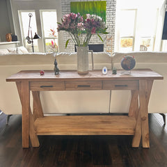 Wooden console table with decorative items in a living room setting