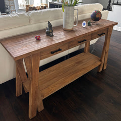 Wooden coffee table with decorative items in a living room setting